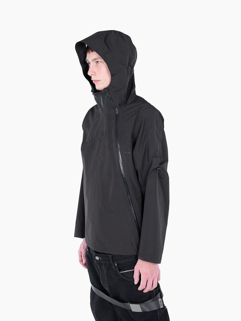 Model wearing a black VAIN shell jacket with a heart-shaped chest yoke, waterproof zippers, and an adjustable hood.