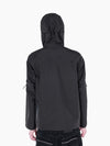 Back view of VAIN black waterproof shell jacket with signature heart-shaped yoke, hood, and taped seams on a model.