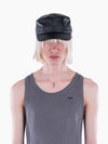 Model wearing a black VAIN lamb leather cap with a star-shaped deboss and logo stitching on the visor.