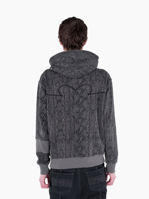 Back view of a model wearing a VAIN Skin Hoodie in grey snake print French terry cotton with a signature back yoke.