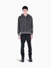 Model wearing a VAIN grey snake print French terry cotton zip-up hoodie with rib sleeve detail and black jeans.